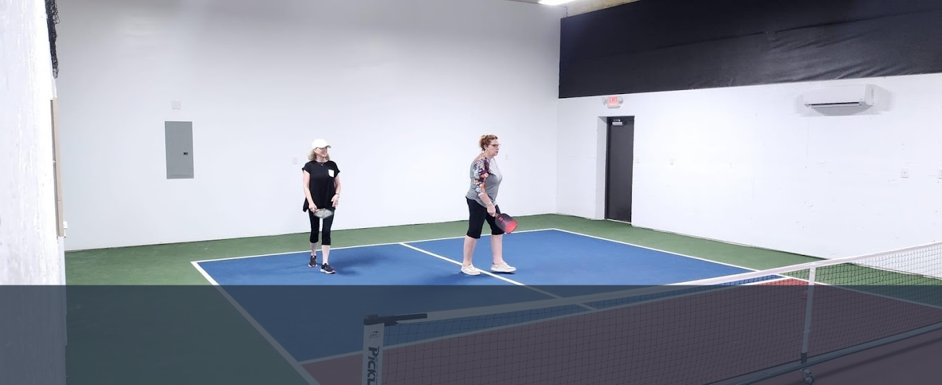 two women are playing a game of pickleball