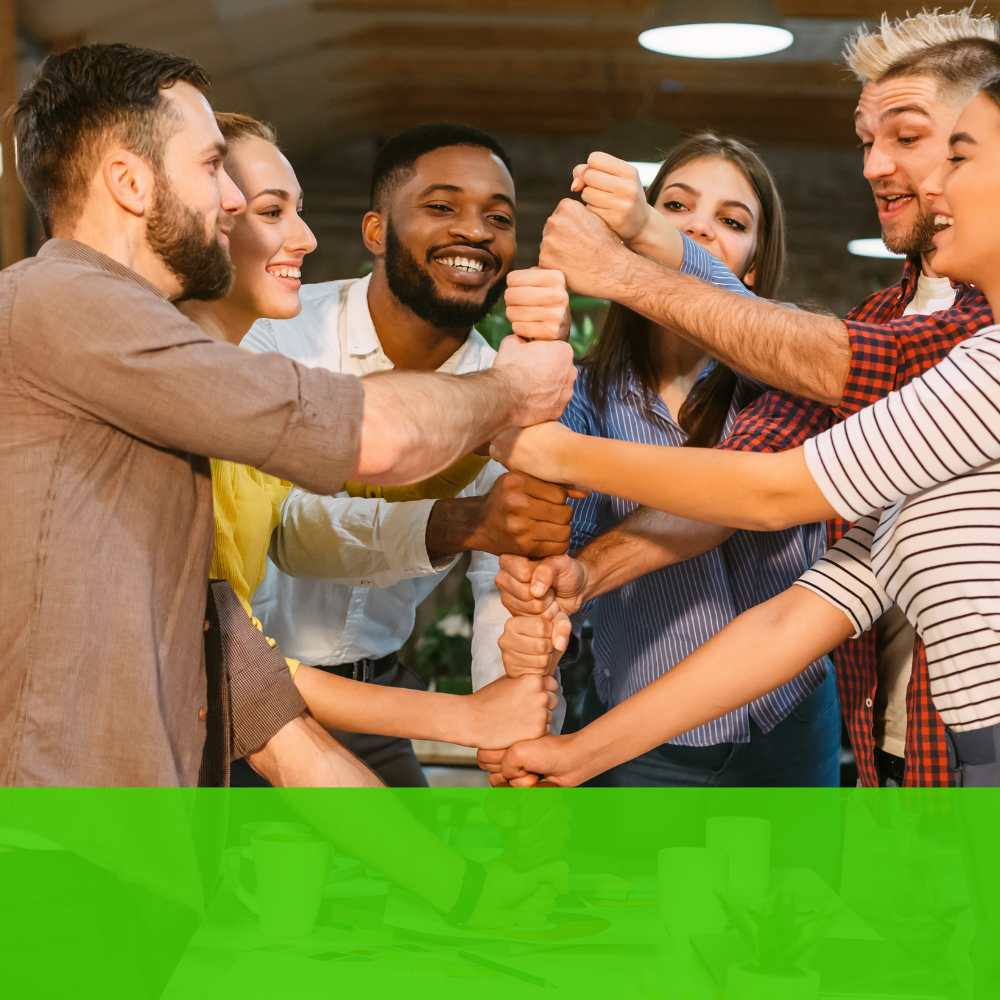 a group of people putting their hands together in a circle