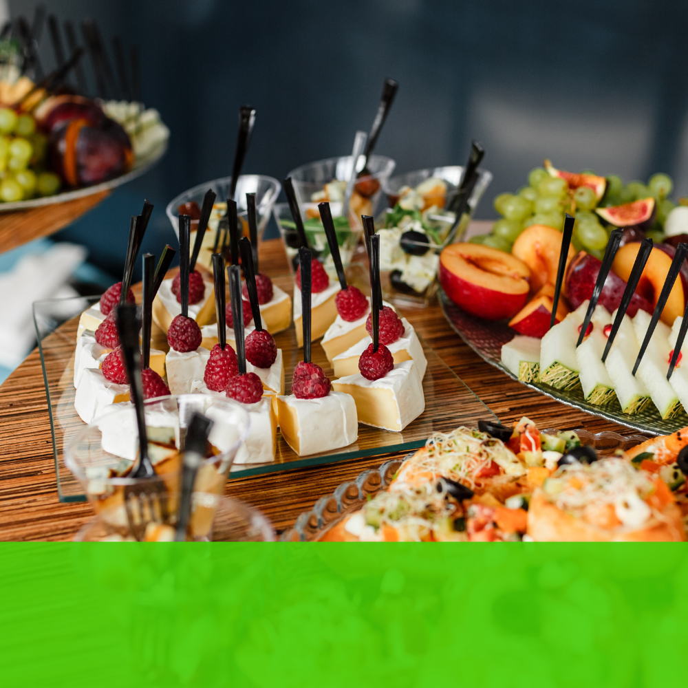 a table with a variety of food including cheese and raspberries