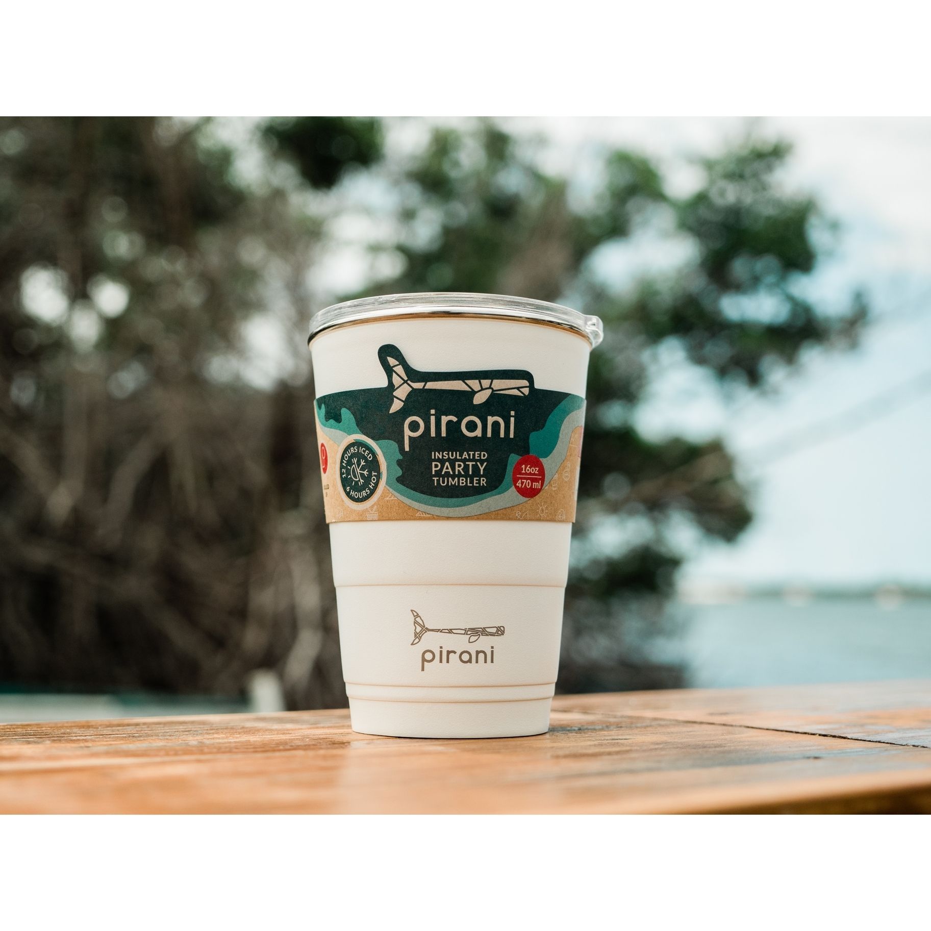 A pirani cup is sitting on a wooden table.