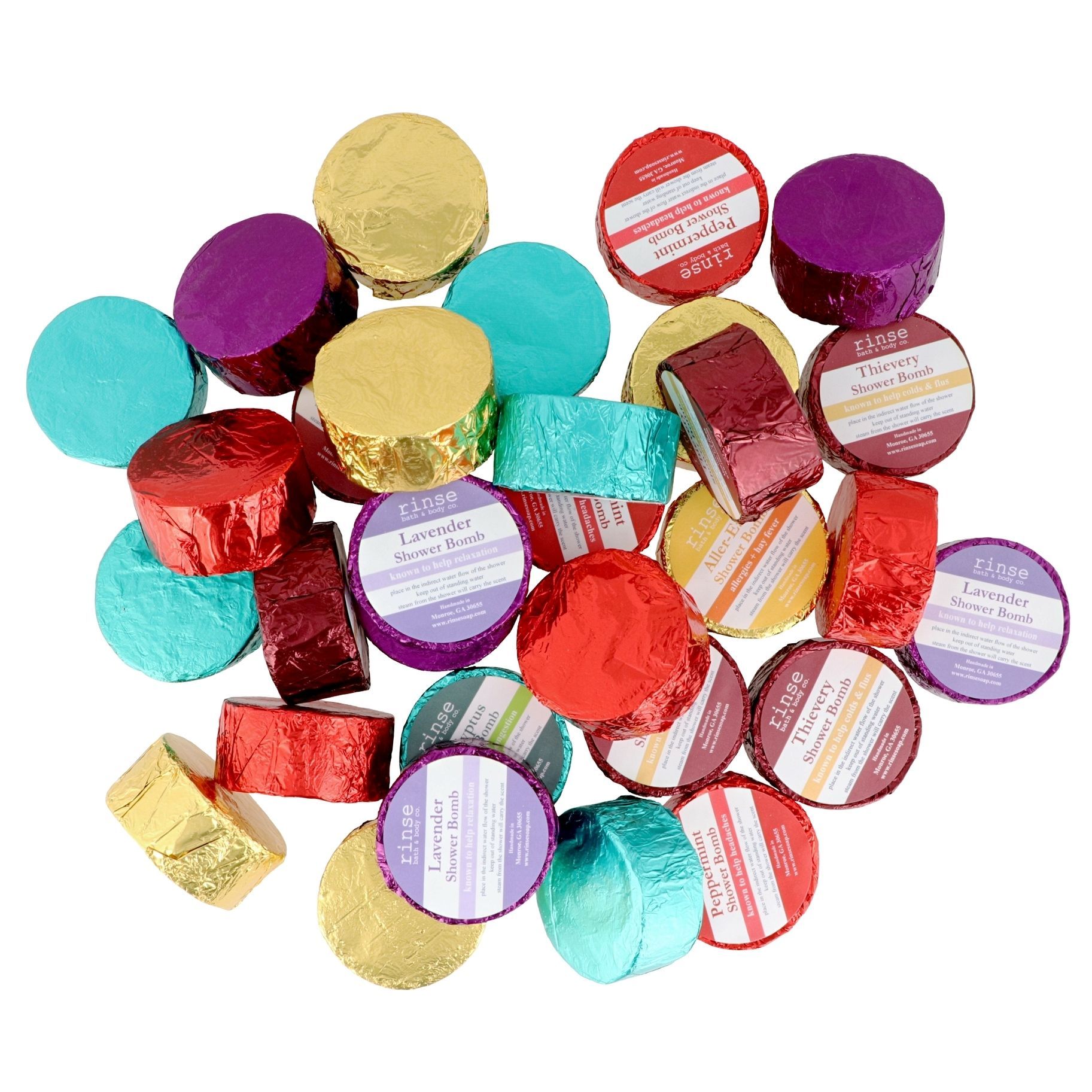 A pile of colorful candy wrapped in foil on a white background.