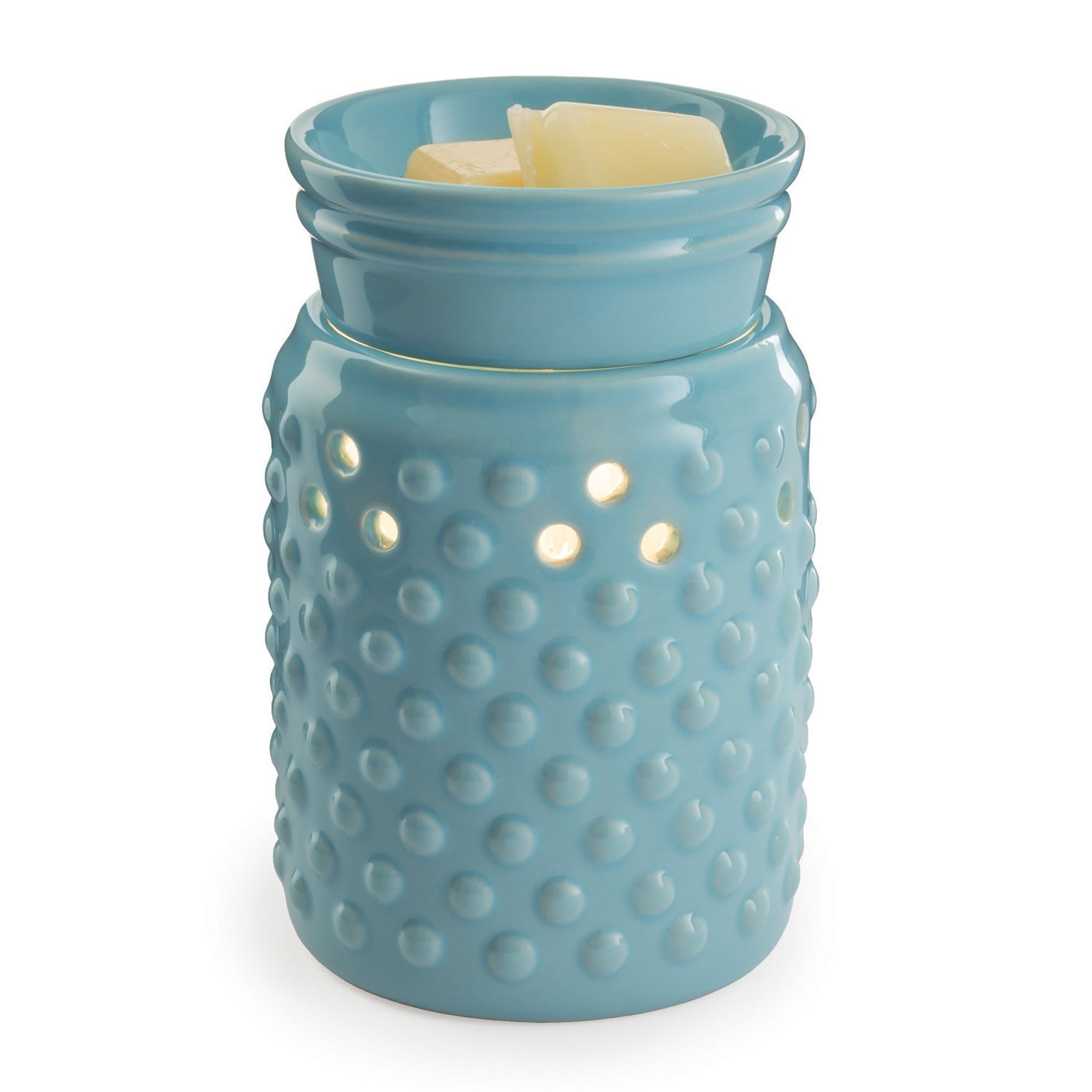 A blue candle holder with a candle in it