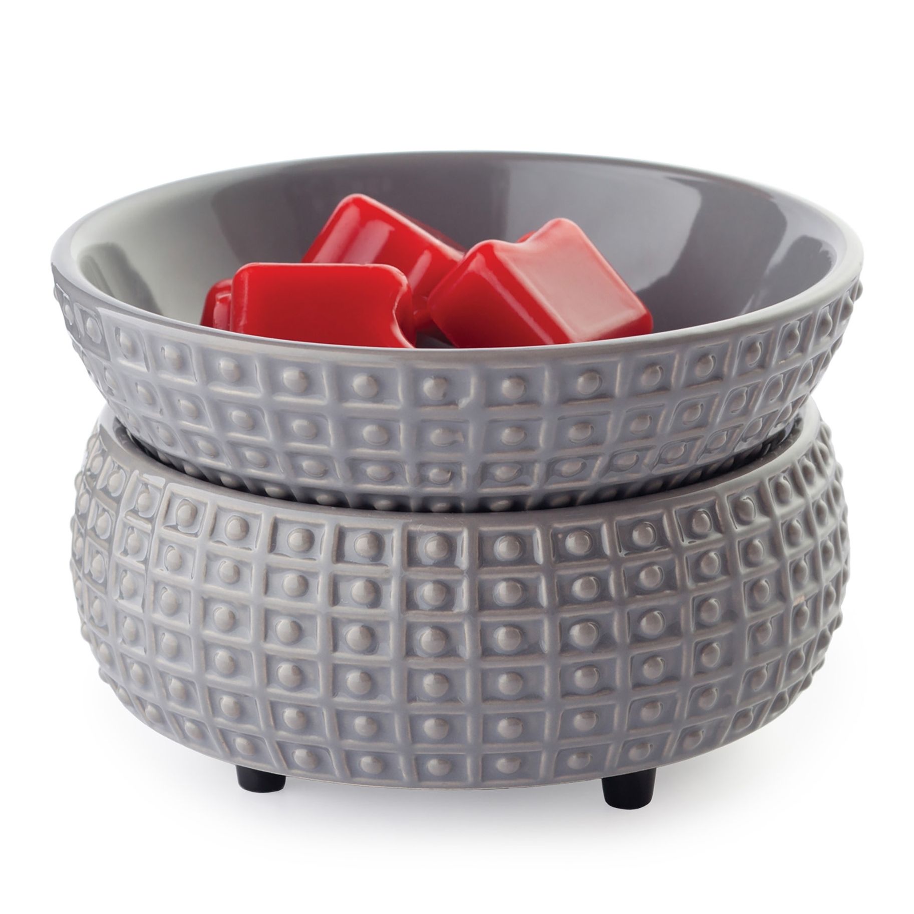 A gray bowl with red wax cubes in it