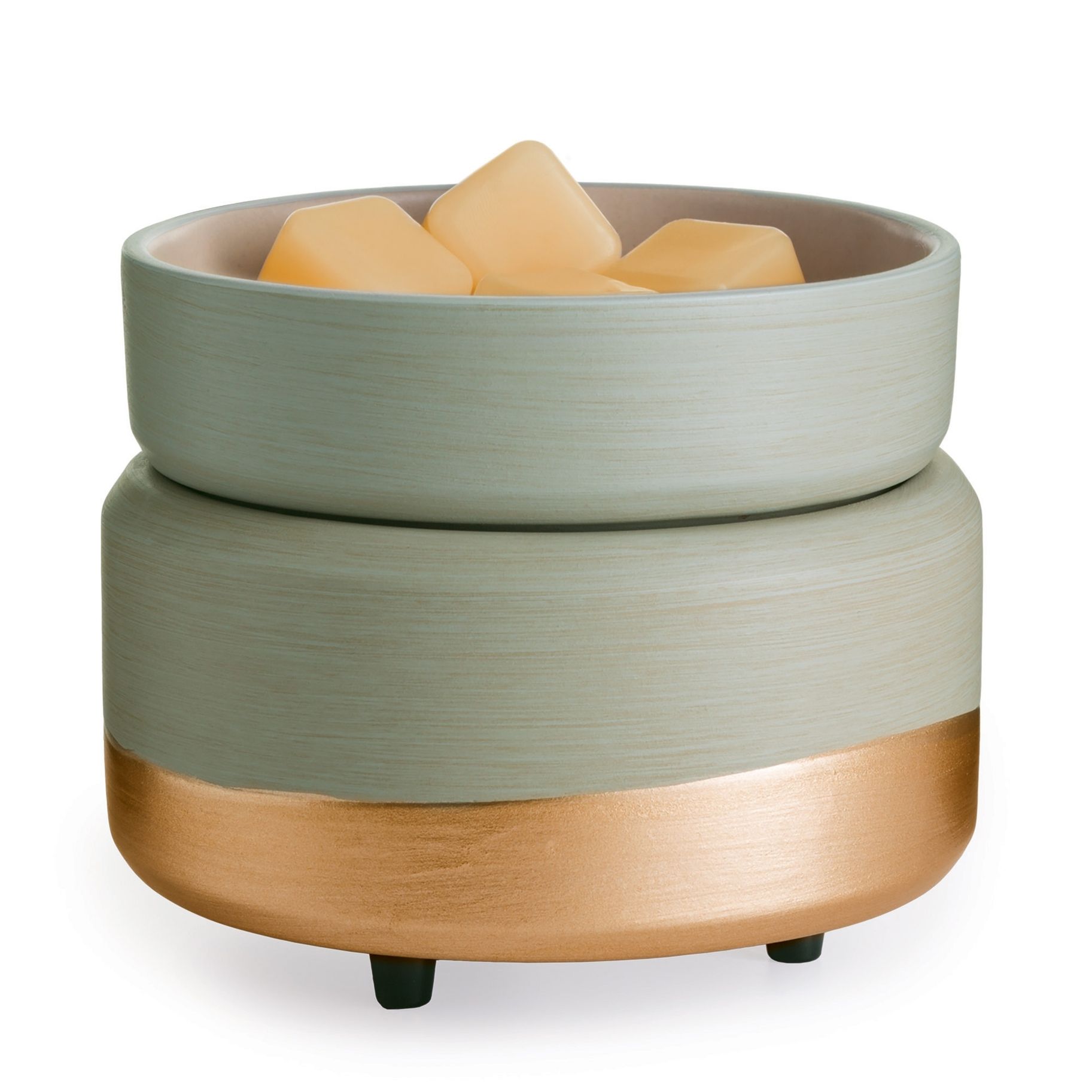 A green and gold bowl filled with wax cubes