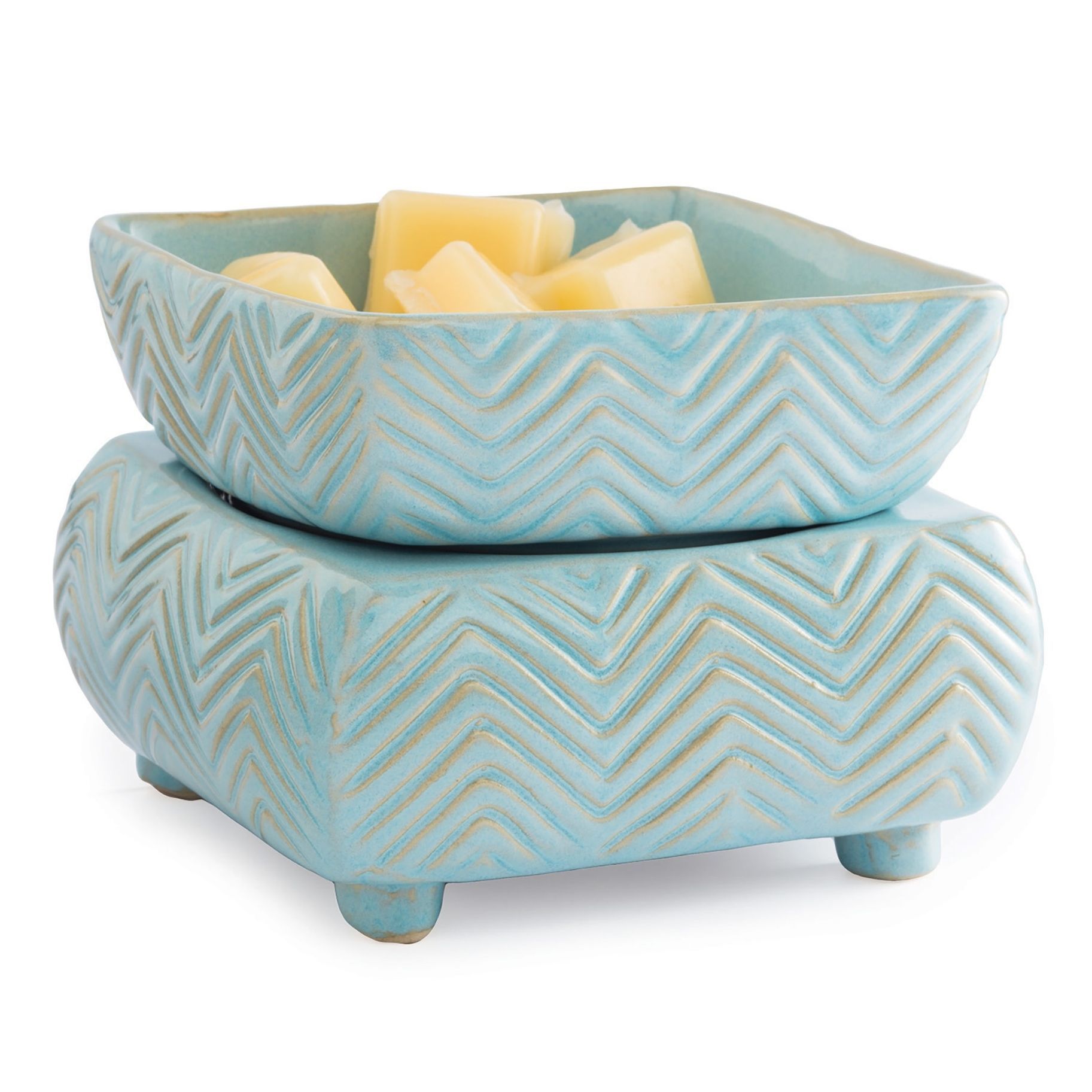 A blue ceramic bowl filled with candles on a white background.