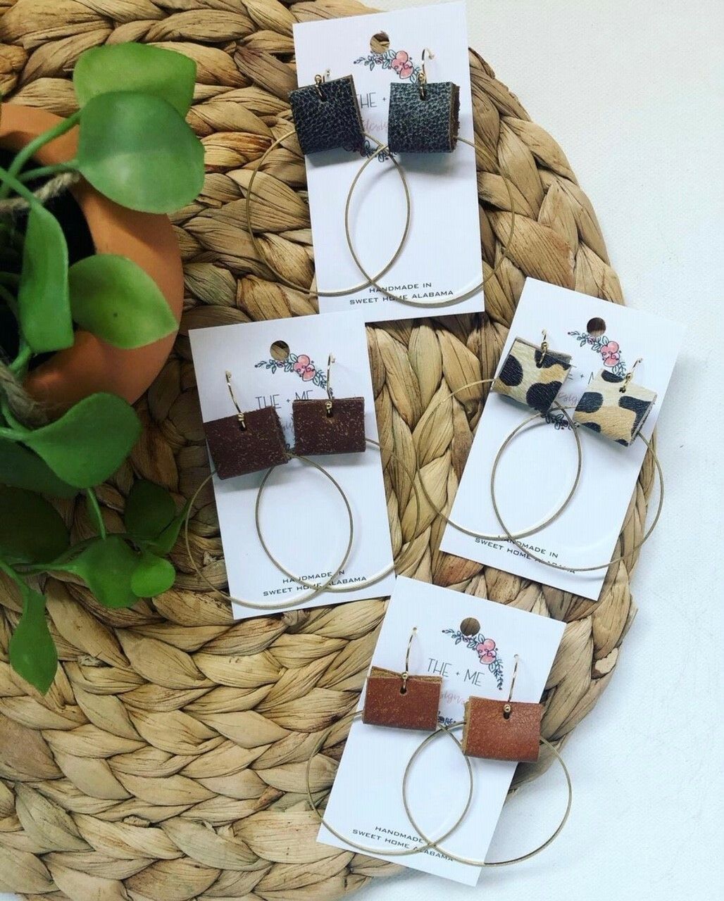 A bunch of earrings are sitting on a wicker mat