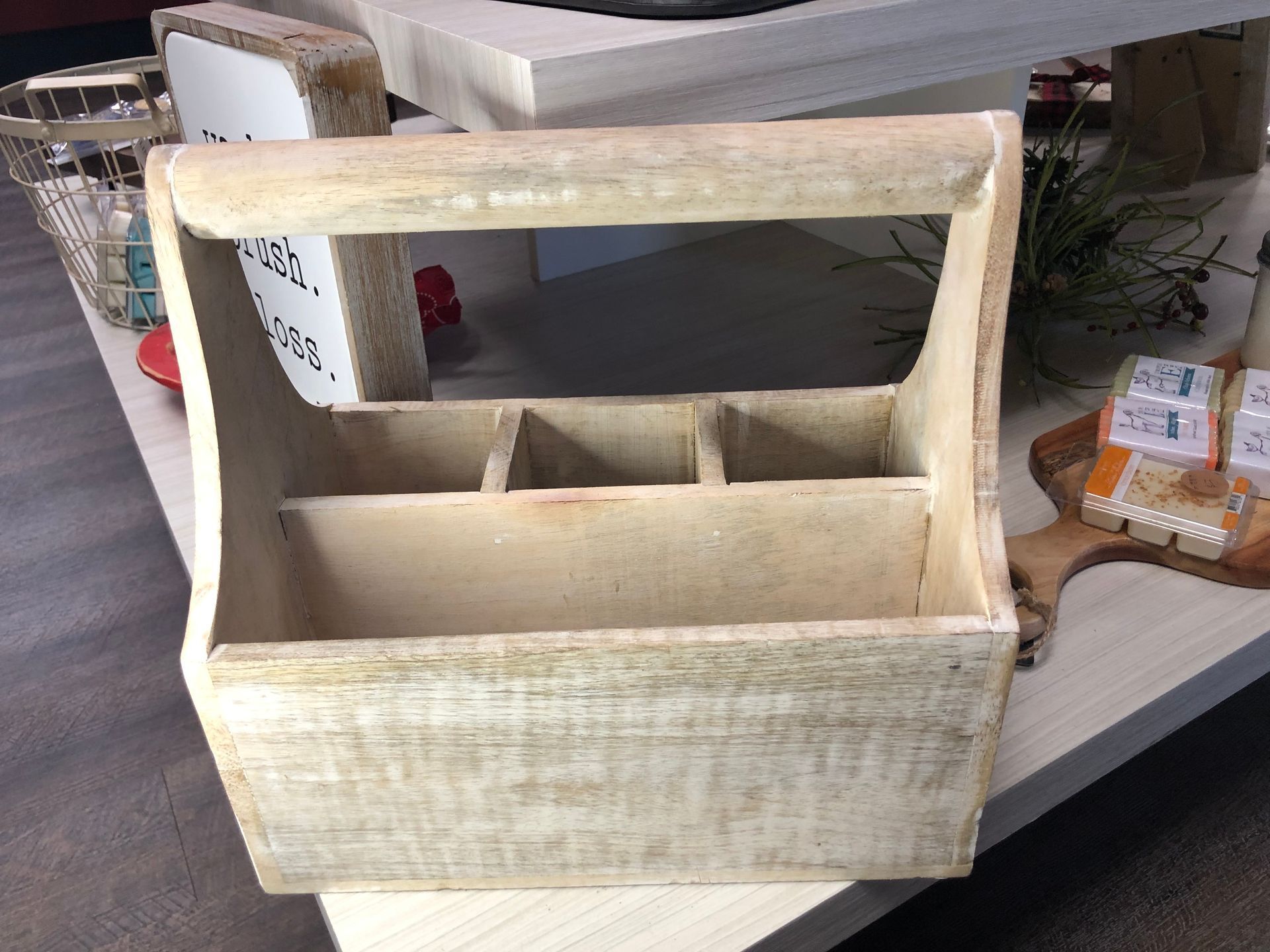 A wooden box with a handle is sitting on a table.