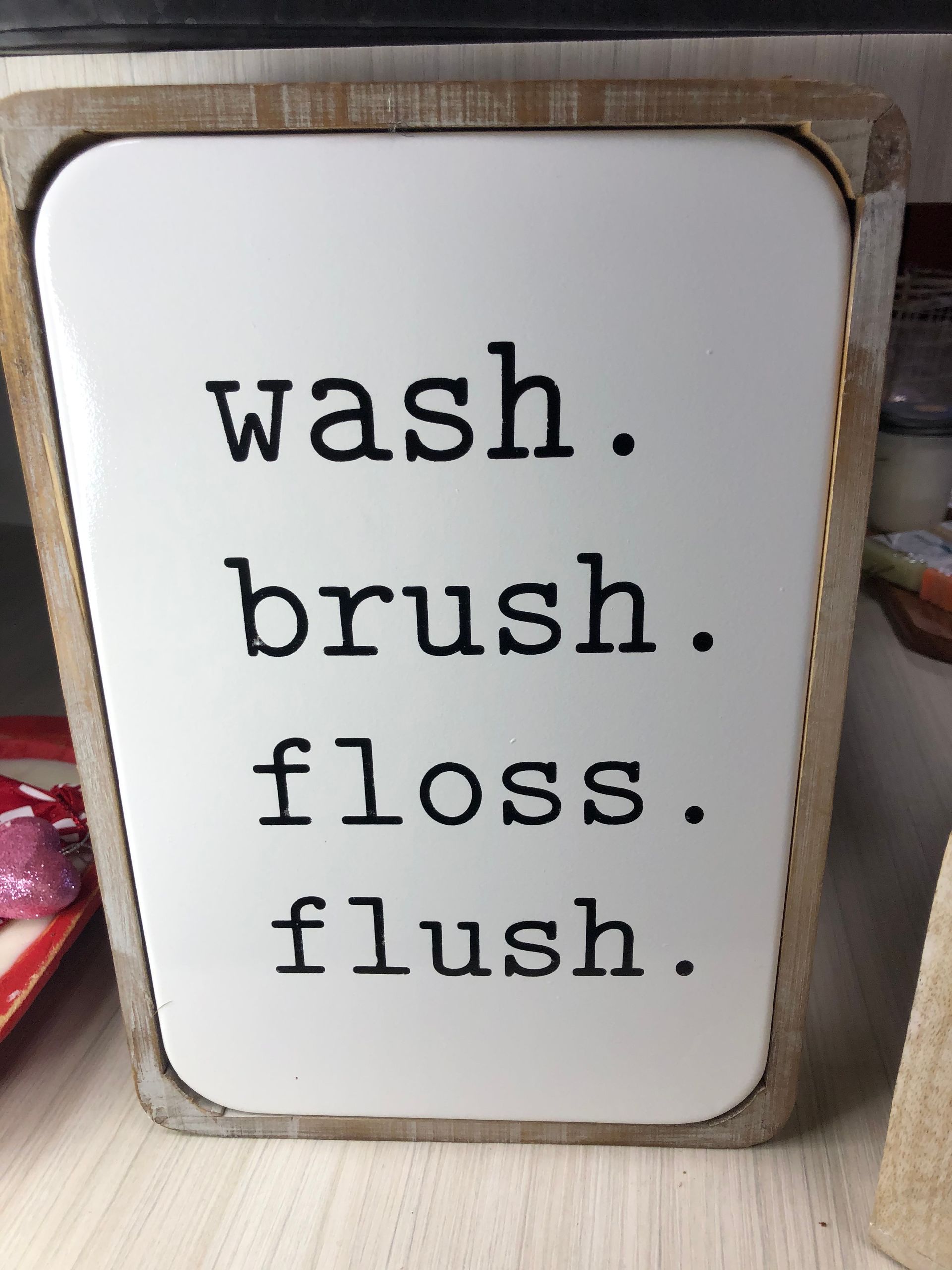 A sign that says wash brush floss flush