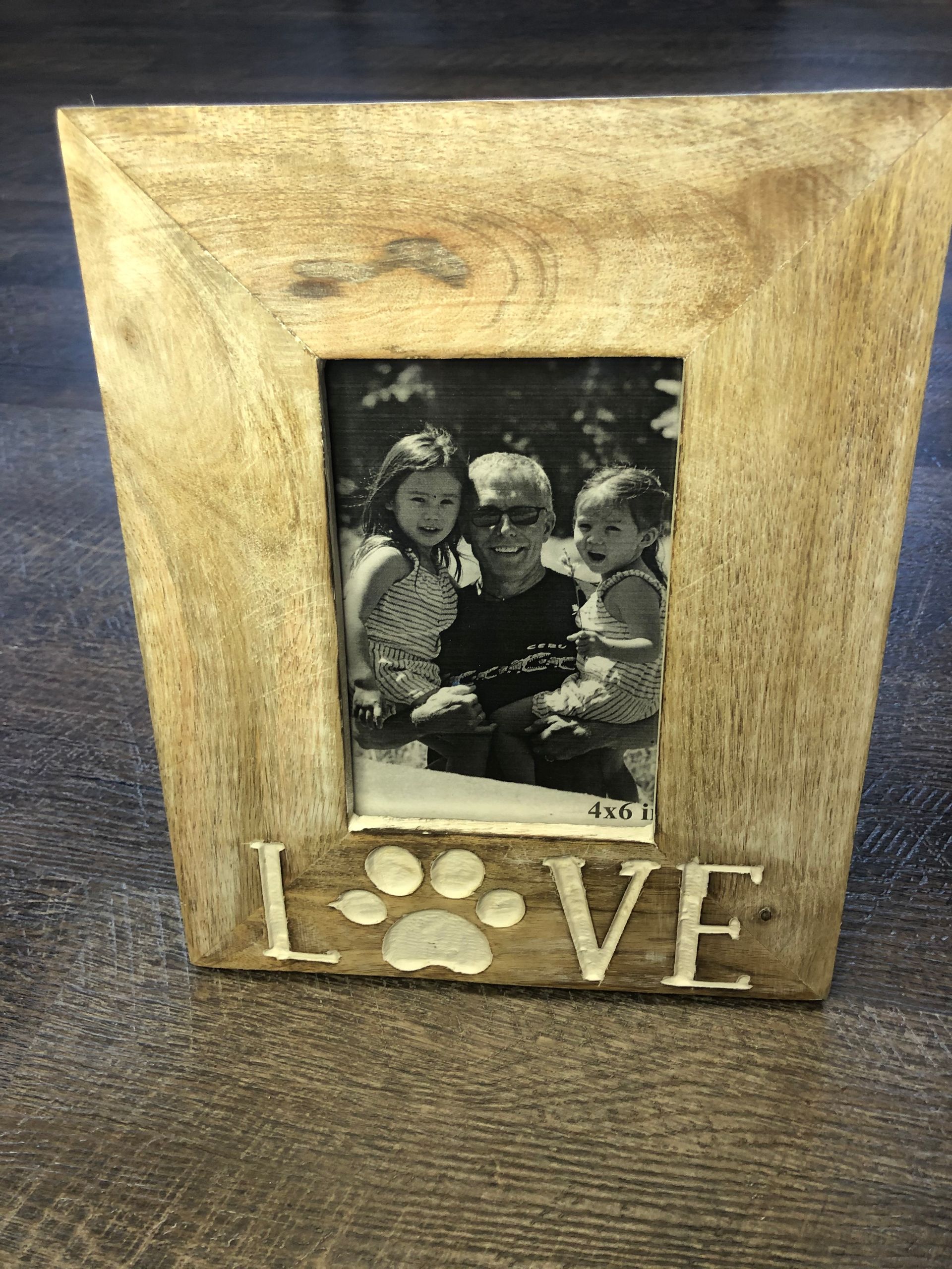 A picture frame with a picture of a family and the word love on it.