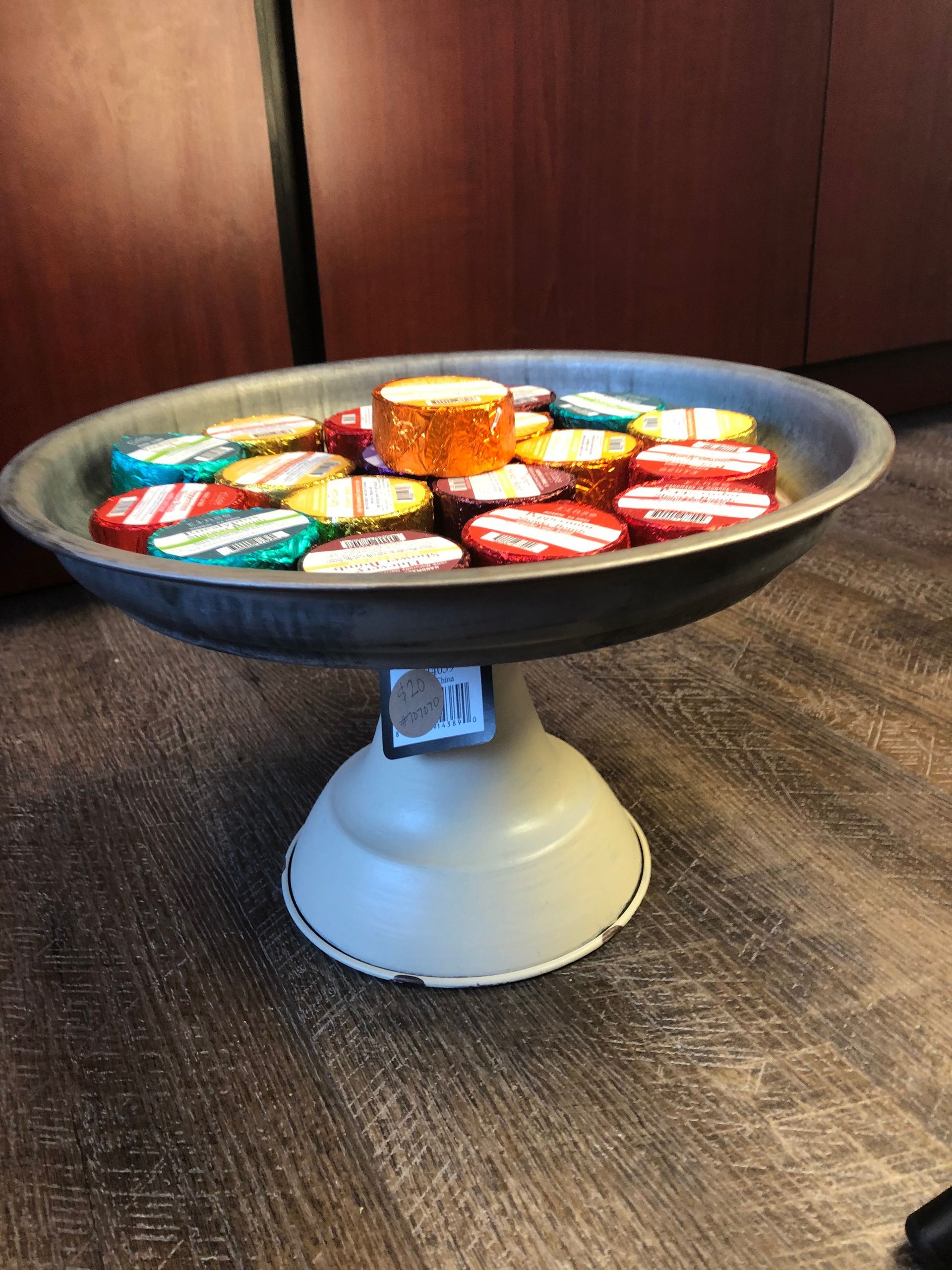 A tray filled with coca cola bottle caps on a table