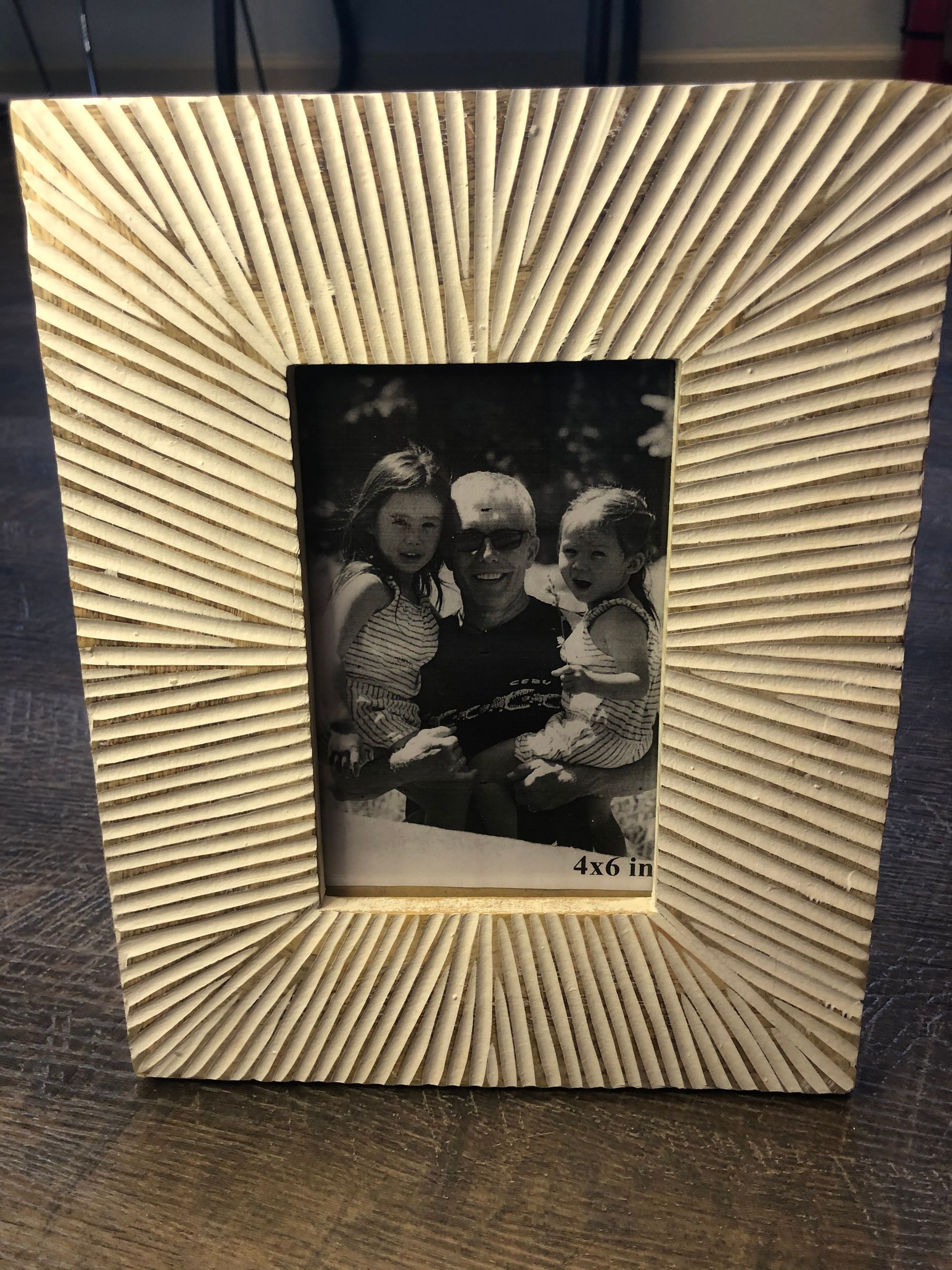 A picture frame with a picture of a family in it