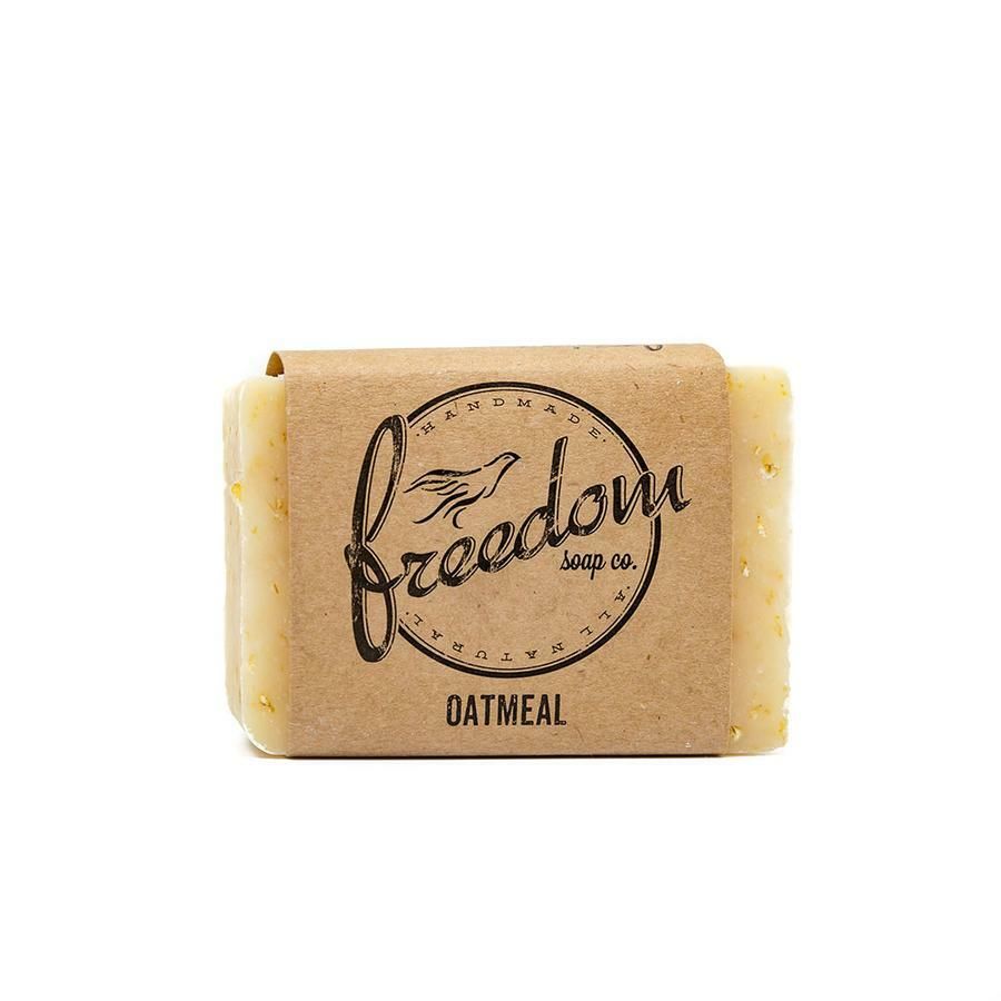 A bar of soap with oatmeal on it is on a white background.