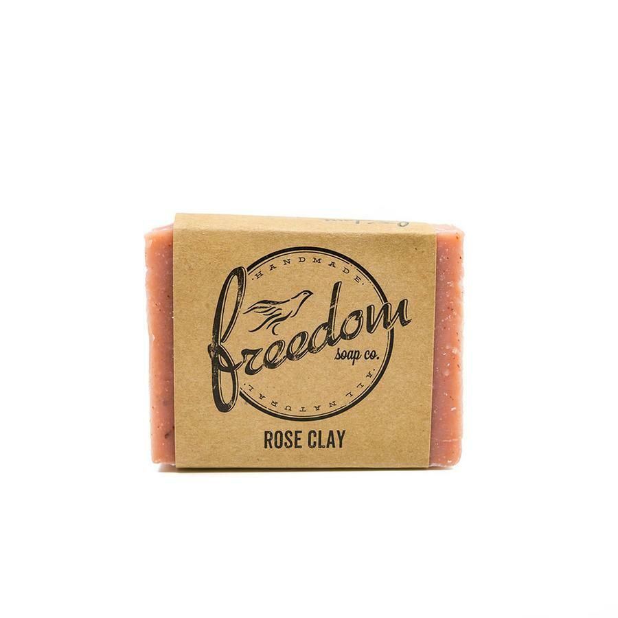 A bar of soap made by freedom soap co. is sitting on a white surface.