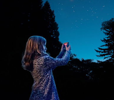 Girl viewing night sky device