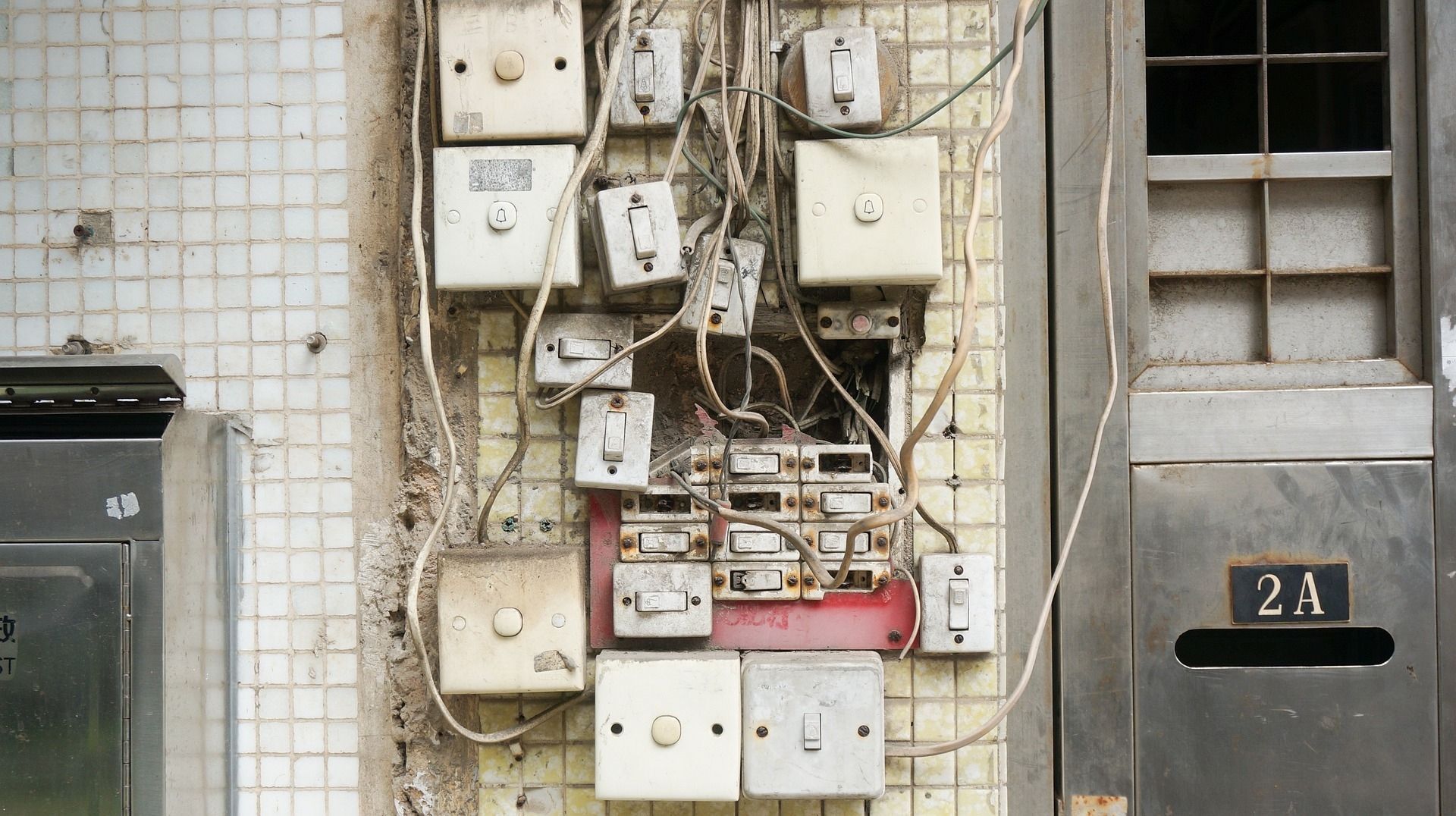 a wall with a bunch of electrical boxes on it