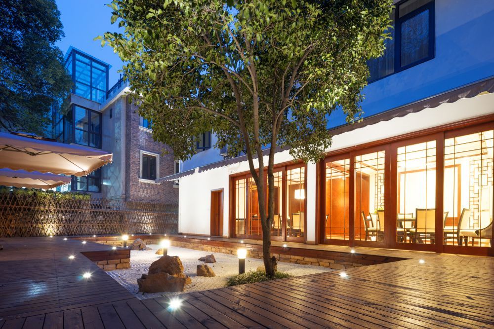 a large building with a lot of windows and a tree in front of it