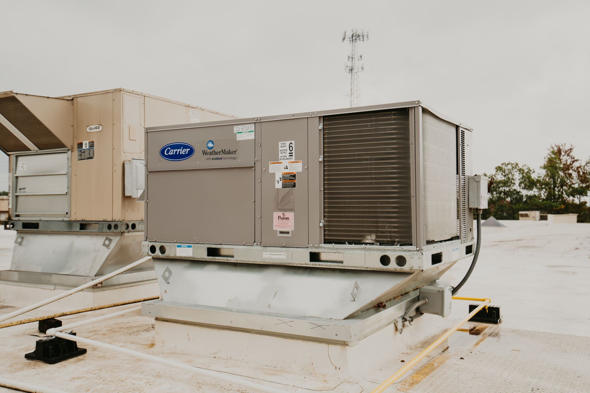 A large air conditioner is sitting on top of a roof.