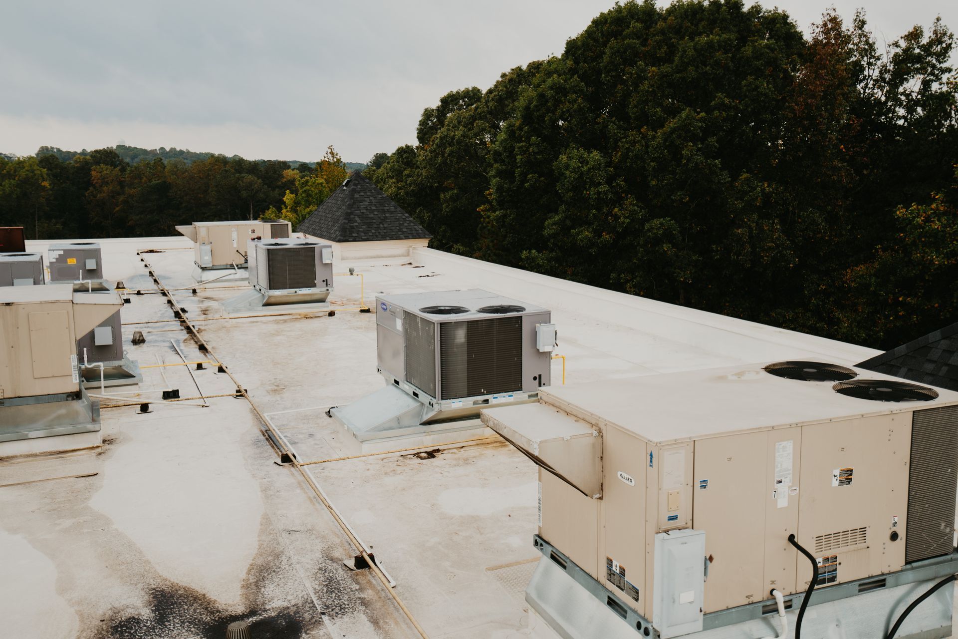 A roof with a lot of air conditioners on it
