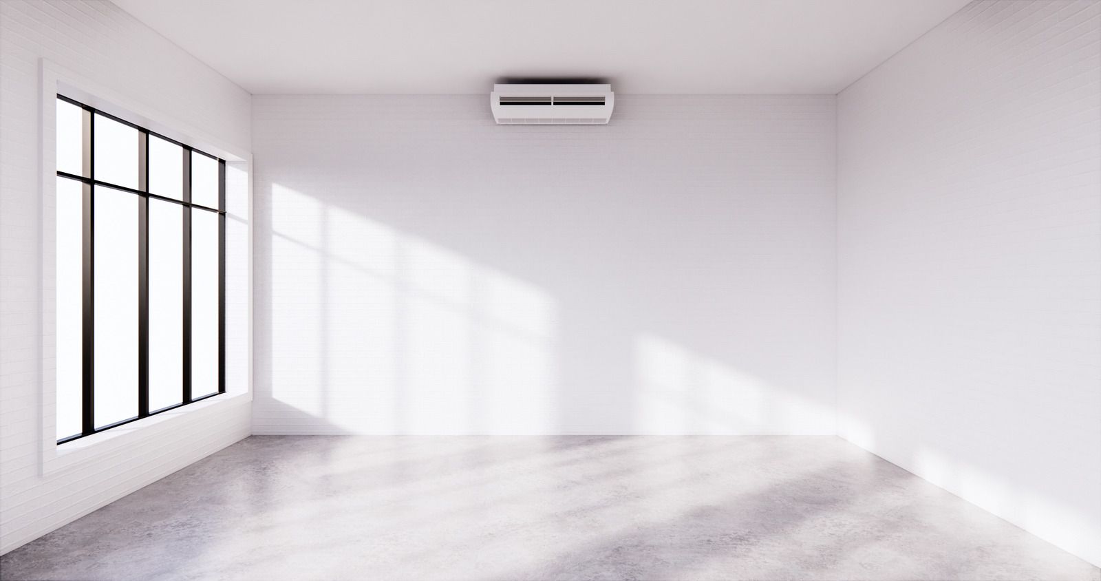 Bright empty room with white walls, large window, gray floor, and a wall-mounted air conditioner