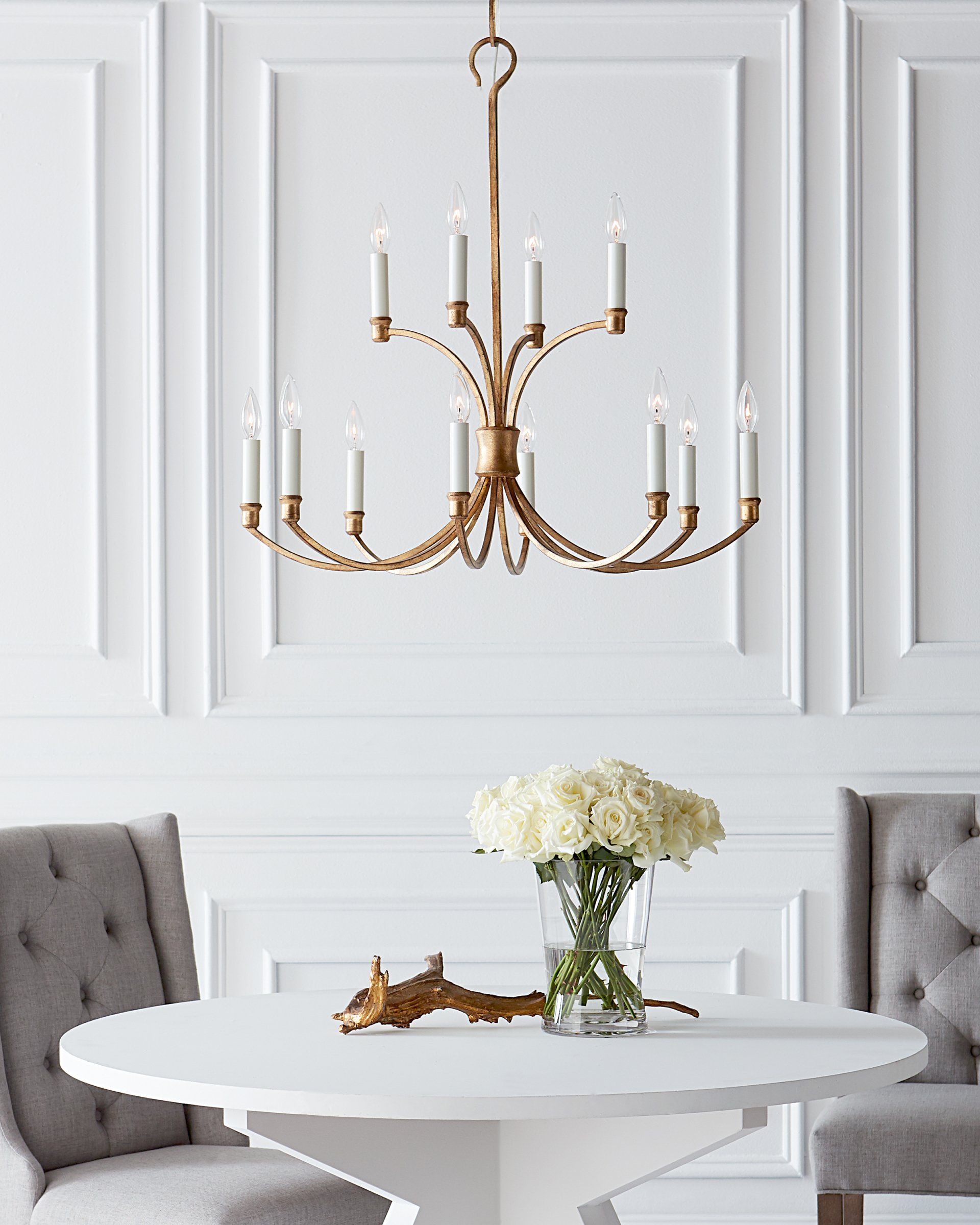 a white table with a vase of flowers on it
