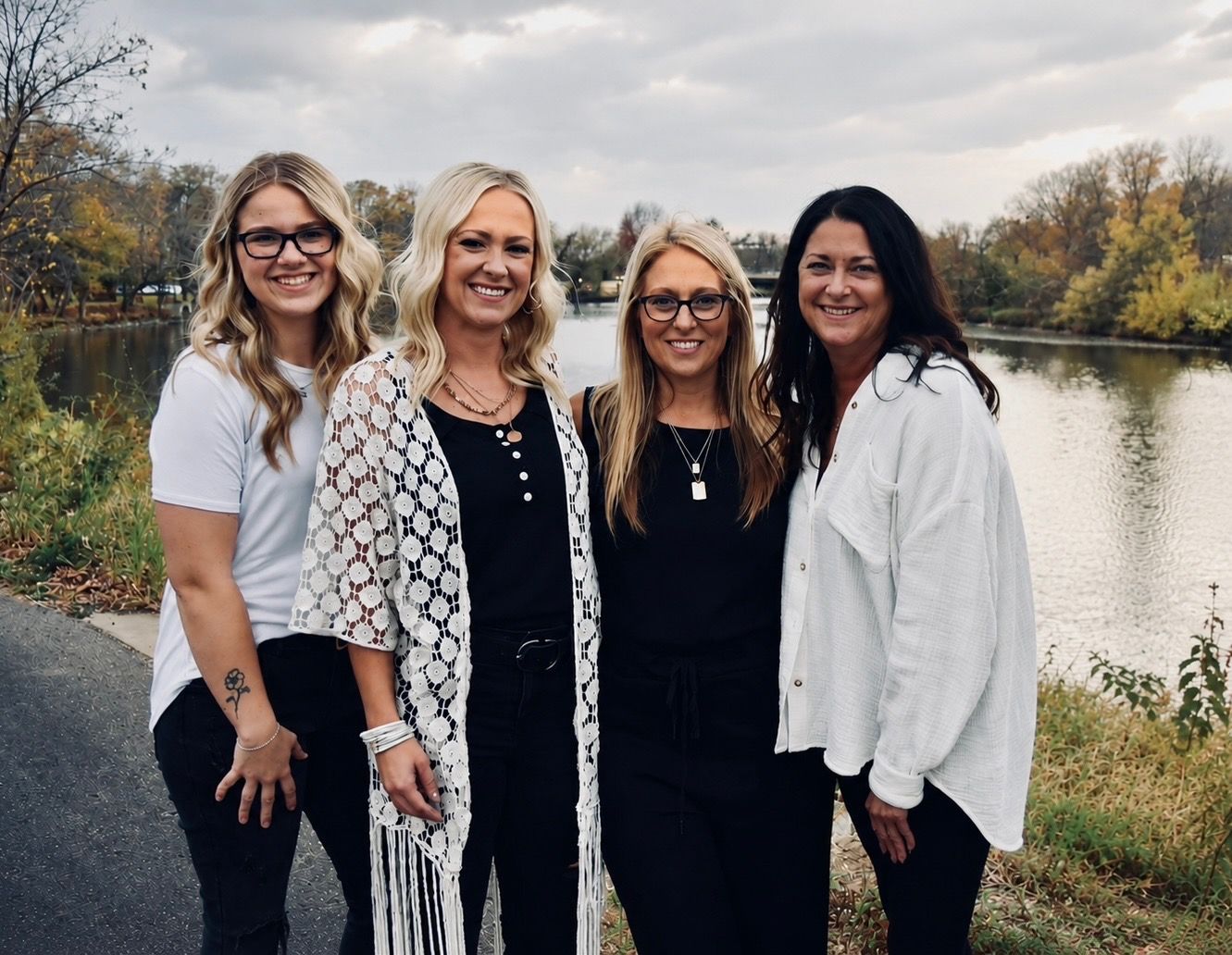 The Professionals from Family Hair salon are smiling for the camera outside.