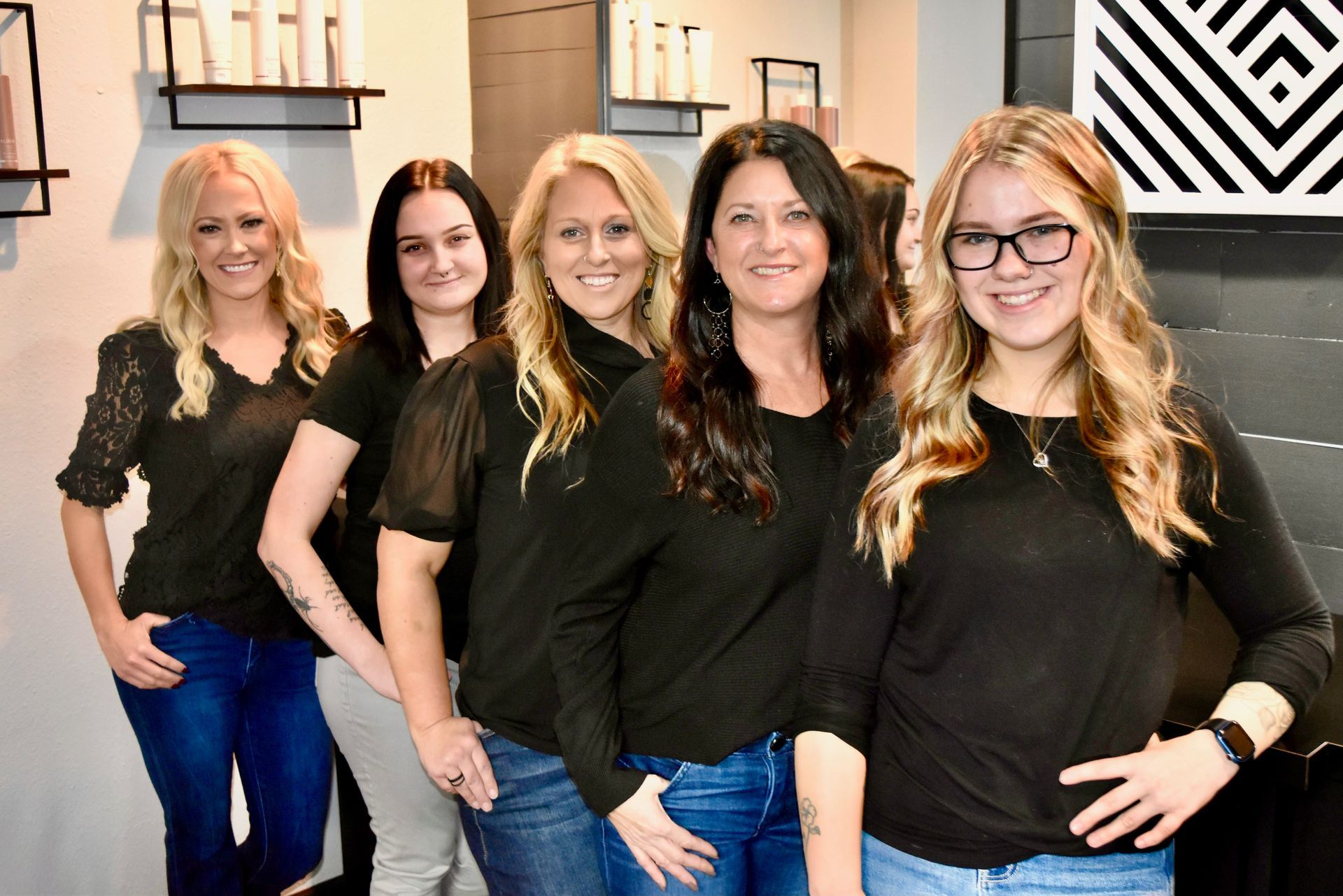The Family Hair salon team are posing for a picture in a room.