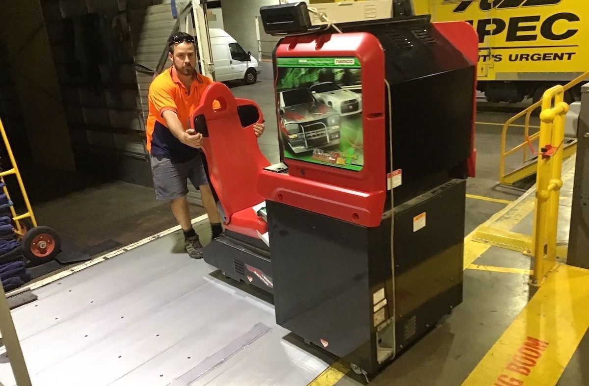 Lewis moving a car racing arcade game.