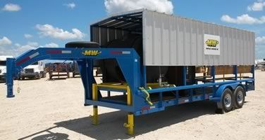 A blue trailer with a white container on top of it.