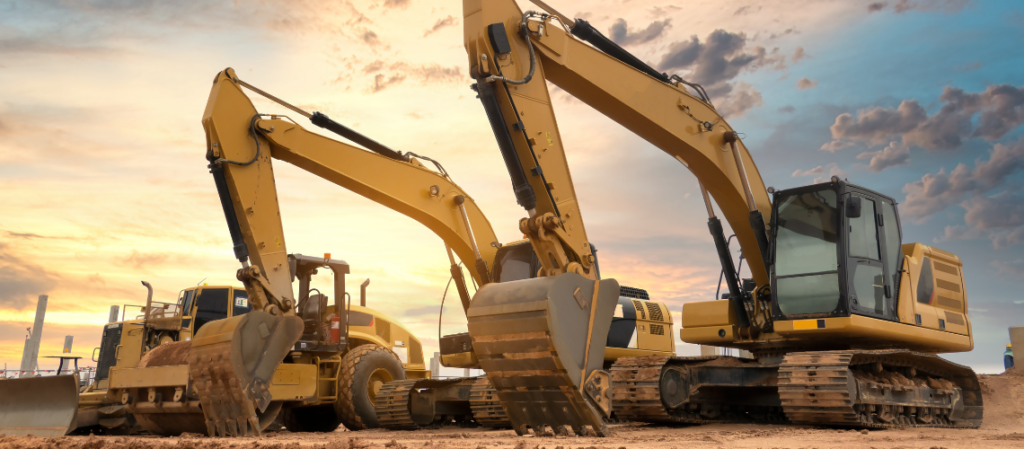 Two bulldozers are parked next to each other on a construction site.