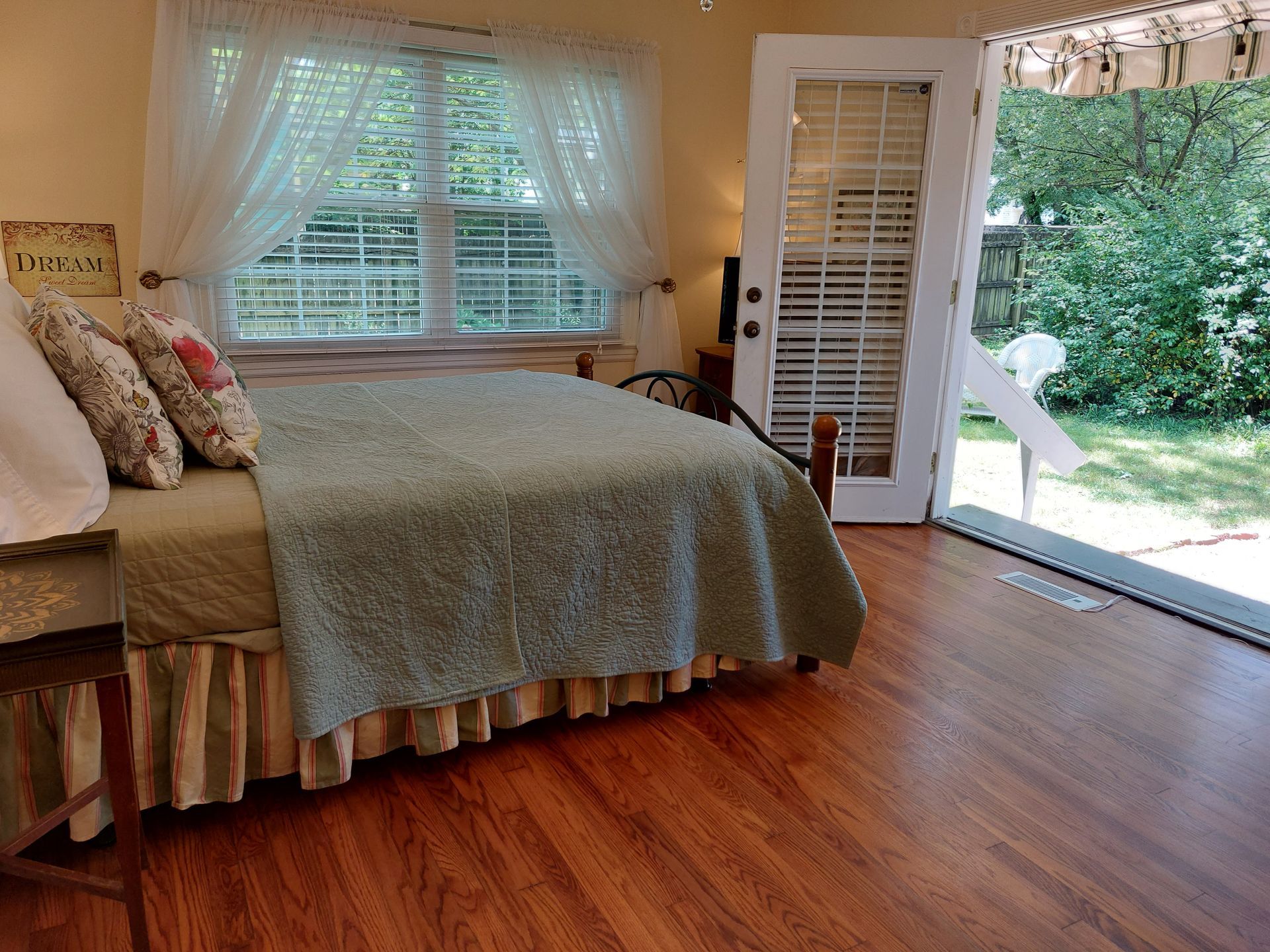 A bedroom with a bed and a sliding glass door