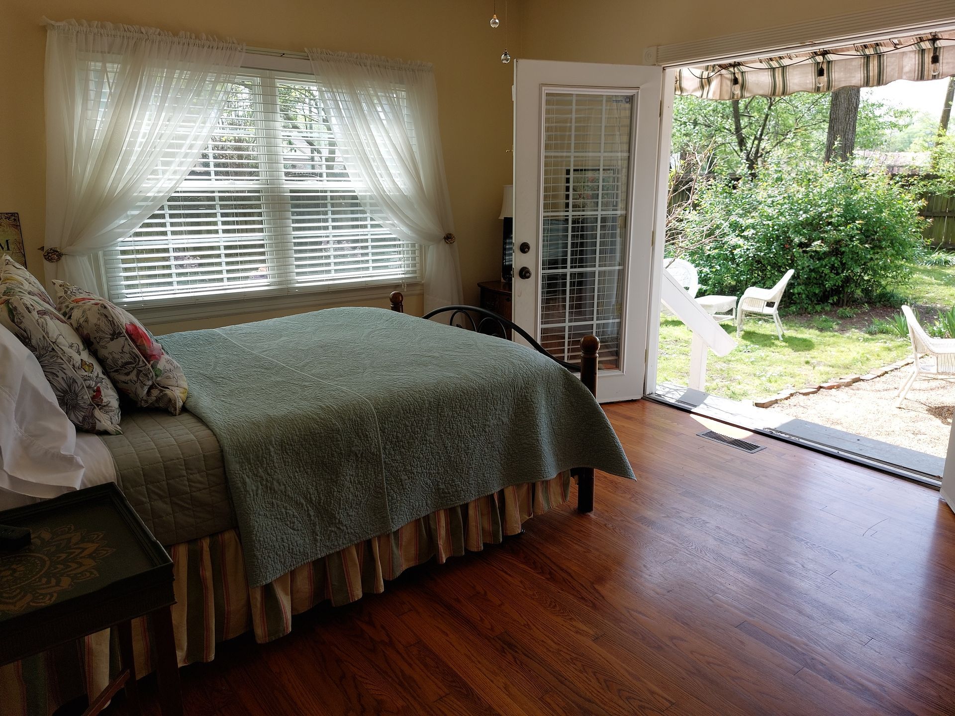 A bedroom with a bed and a sliding glass door