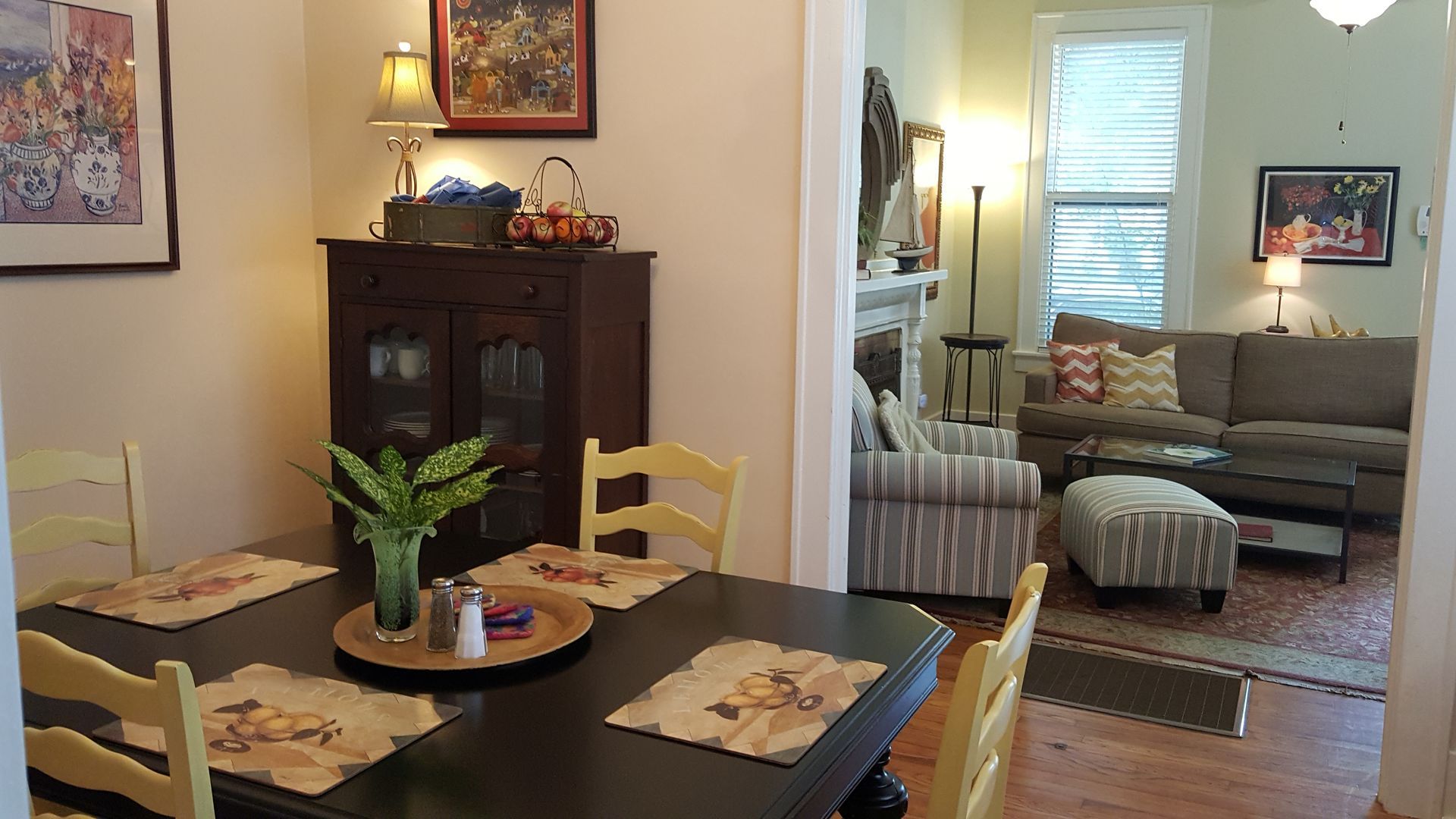 A dining room table and chairs in a living room