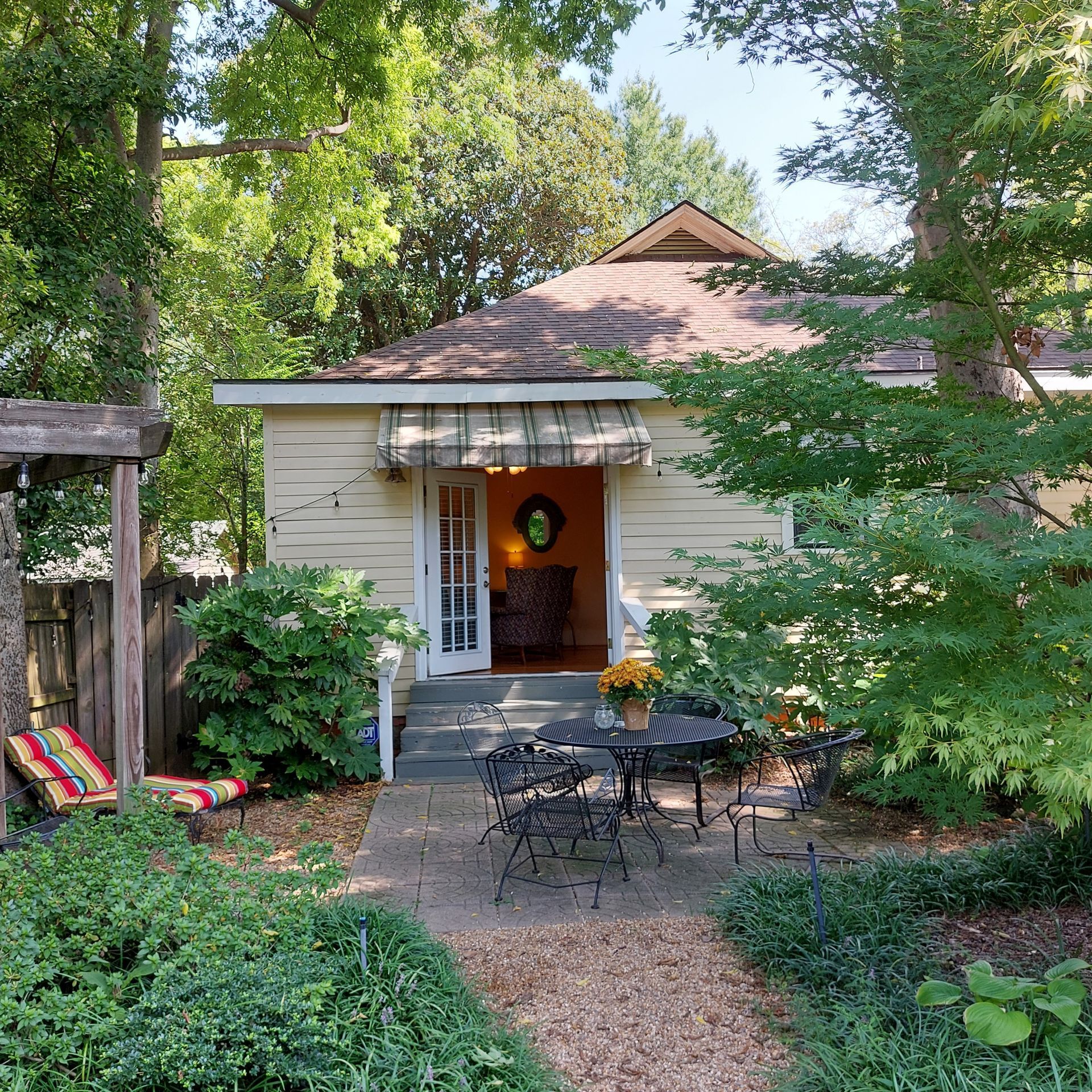 A small house with a table and chairs in front of it