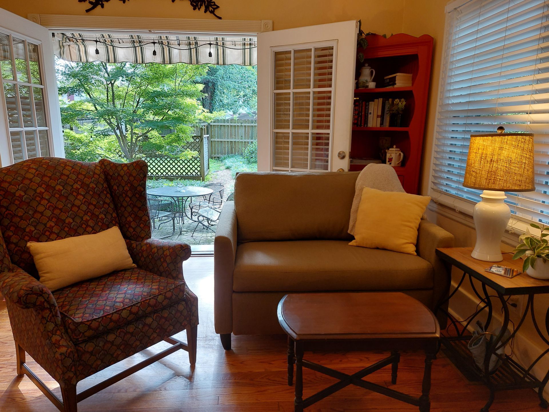 A living room with a couch and two chairs