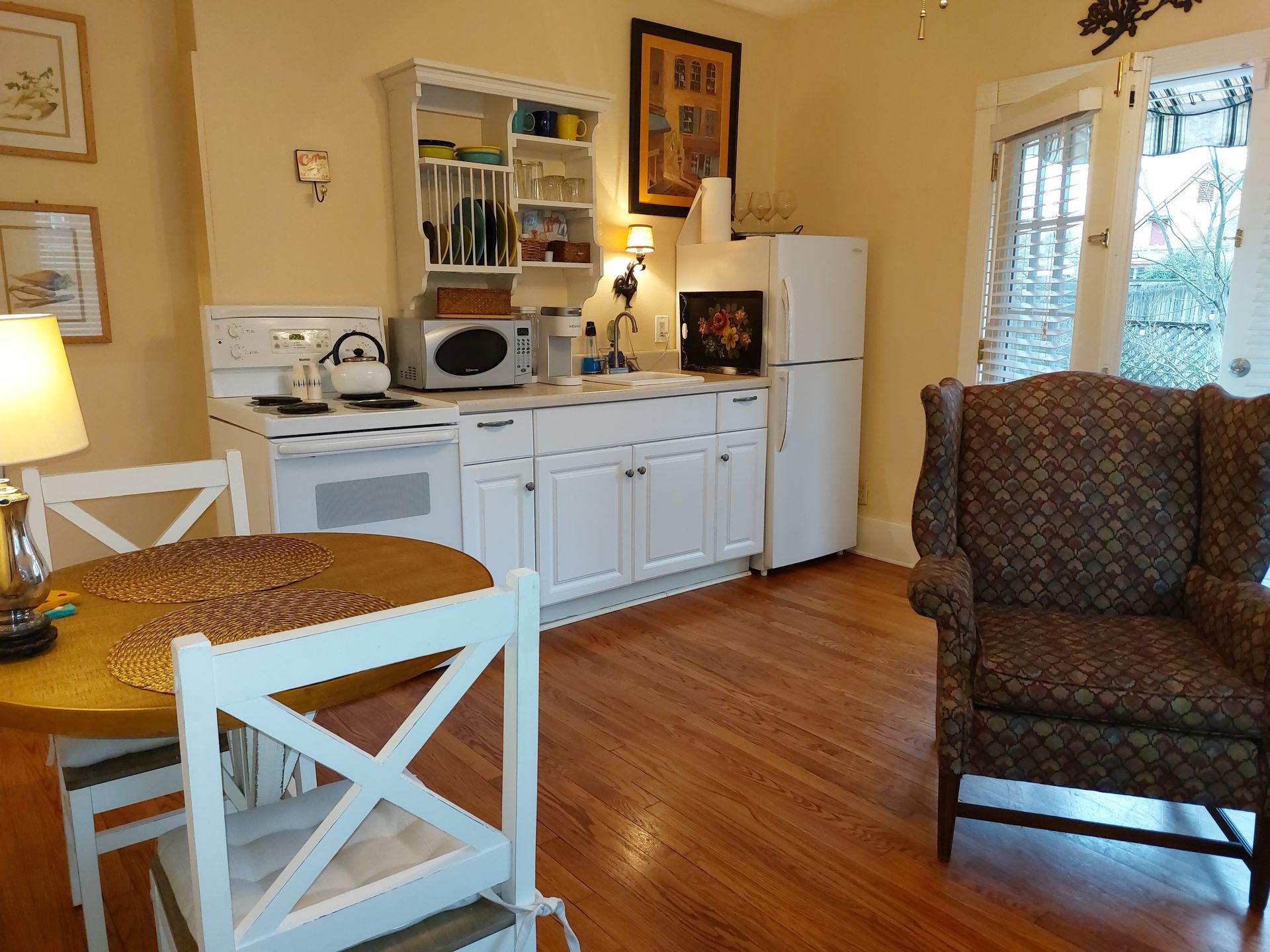 A kitchen with a table and chairs and a refrigerator