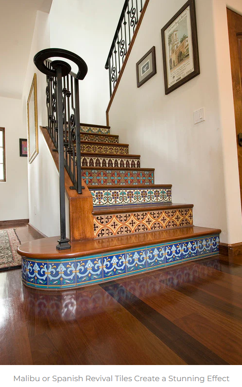 Spanish-style tiled staircase with ornate iron railing and polished wood floor indoors