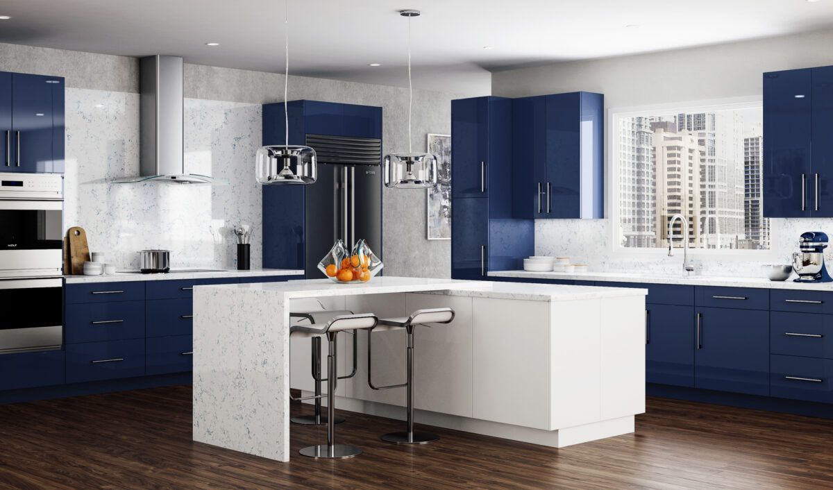 Modern kitchen with navy cabinets, white island, and wood floors, lit by large windows