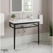 Modern black metal bathroom vanity with white sink, mirror, and wall-mounted towel ring in a bright room