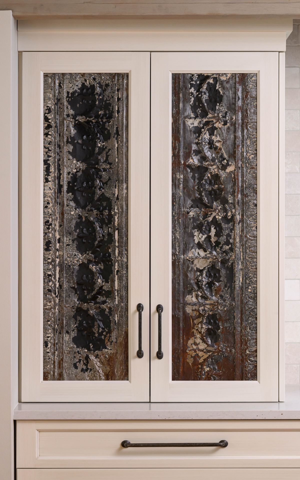 Beige double cabinet doors with frosted glass panels and dark metal handles