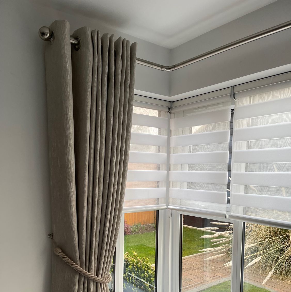 A window with curtains and blinds on it.