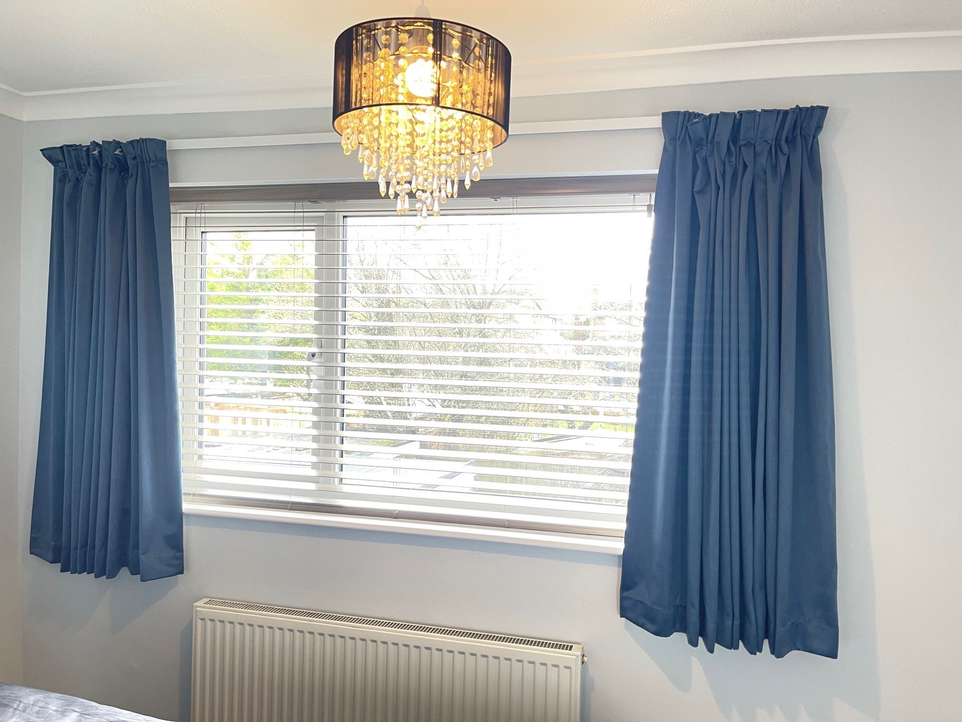 Curtains with a blackout lining  on a white metal track
