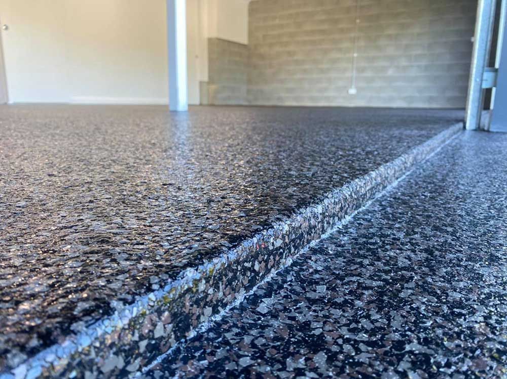 A close up of a concrete floor in a garage.