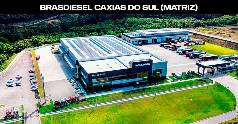 Vista aérea das instalações da concessionária Bradiesel Scania em Caxias do Sul, Brasil, com caminhões estacionados no pátio.