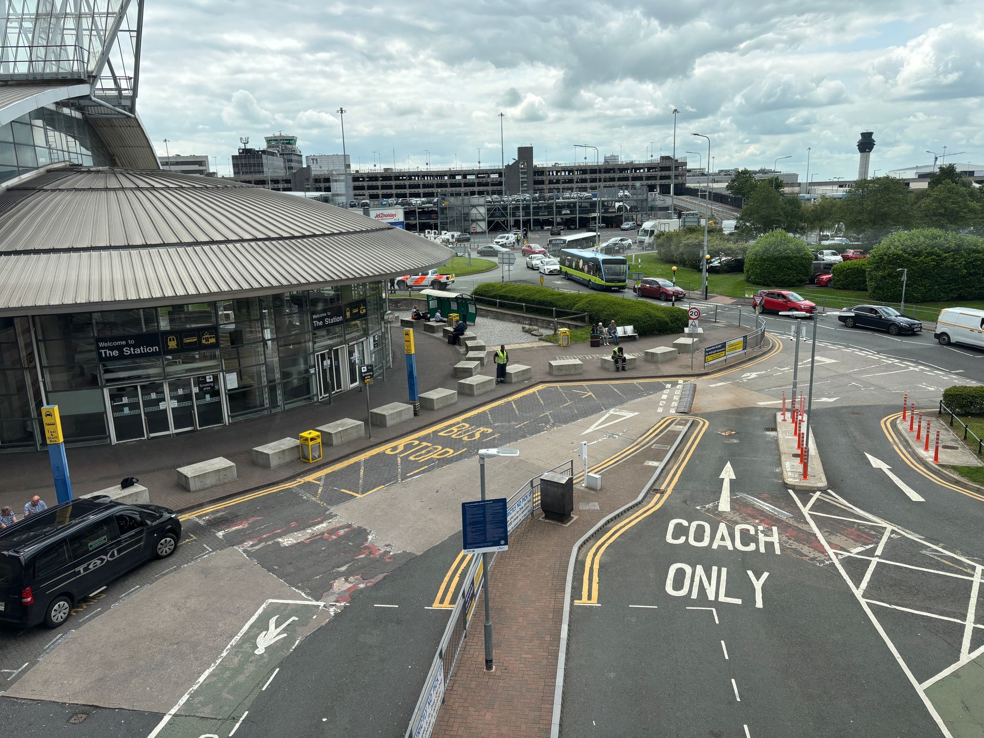 An aerial view of an airport drop-off area with a 