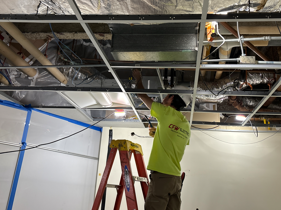 Commercial electrician working on a tenant build-out electrical panel