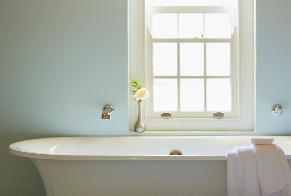 A Bathtub in A Bathroom Next to A Window — Canberra Kitchen & Bathroom in Fyshwick, ACT