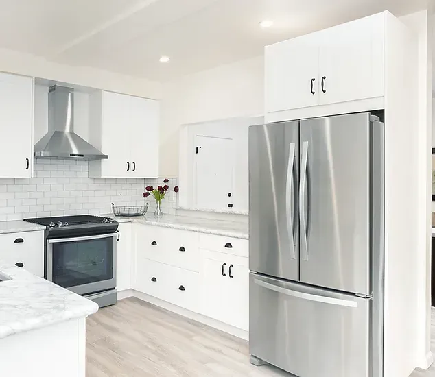 A Kitchen with Stainless Steel Appliances and White Cabinets — Canberra Kitchen & Bathroom in Fyshwick, ACT