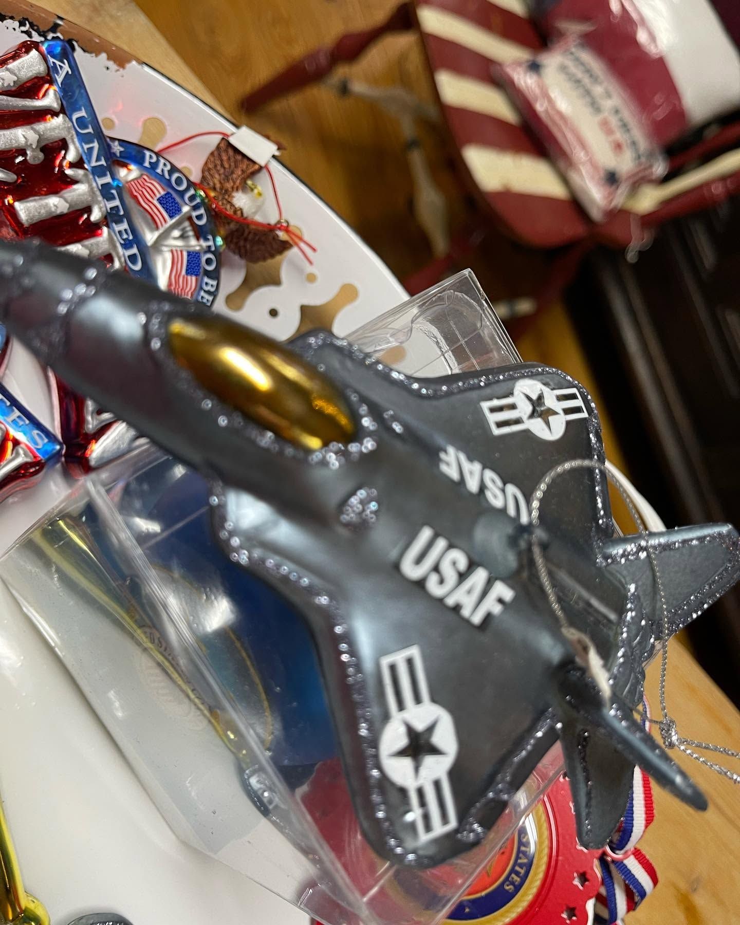 Black USAF jet toy in plastic packaging on a store shelf