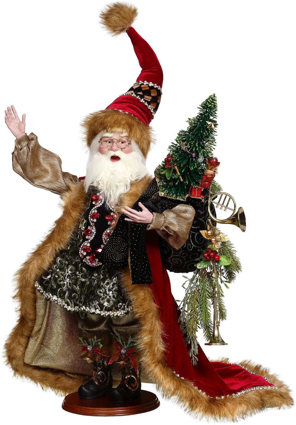 Decorative Santa figurine in gold coat and red hat, holding a small Christmas tree and waving