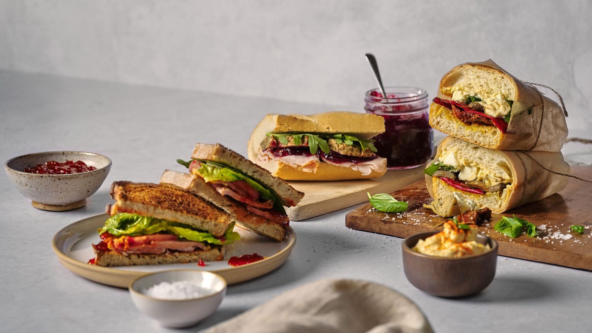 There are many different types of sandwiches on the table.